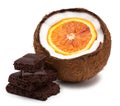 Orange inside coconut and pieces of chocolate isolated on white Royalty Free Stock Photo