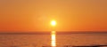 Orange intense sun sunset over water sea ocean Royalty Free Stock Photo