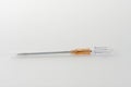 Orange intravenous cannula 14 G on white background, external diameter 2,1 mm, used in trauma, blood transfusion, surgery, ascites