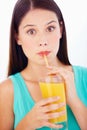 This orange juice is amazing. Portrait of a beautiful young woman sipping orange juice through a straw. Royalty Free Stock Photo