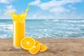 Orange juice on the beach table Royalty Free Stock Photo