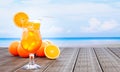 Orange juice in a clear glass with ice cubes and orange juice at the mouth of the glass. Cold drinks placed on the wooden balcony Royalty Free Stock Photo