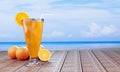 Orange juice in a clear glass with ice cubes and orange juice at the mouth of the glass. Cold drinks placed on the wooden balcony Royalty Free Stock Photo