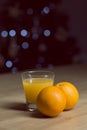 Orange juice on a drinking glass with fresh oranges fruit on a wooden table Royalty Free Stock Photo