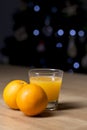 Orange juice on a drinking glass with fresh oranges fruit on a wooden table Royalty Free Stock Photo