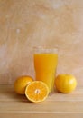 Orange juice in a glass and fresh fruit on table Royalty Free Stock Photo