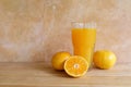 Orange juice in a glass and fresh fruit on table Royalty Free Stock Photo