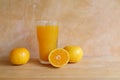 Orange juice in a glass and fresh fruit on table Royalty Free Stock Photo