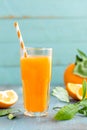 Orange juice in glass and fresh fruits with leaves on wooden background Royalty Free Stock Photo