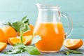 Orange juice in glass and fresh fruits with leaves on wooden background Royalty Free Stock Photo