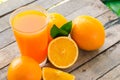 Orange juice in glass , fresh fruits on wooden background