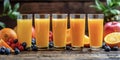 Orange juice in a glass glass, fruits and berries in the background. Royalty Free Stock Photo