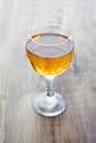 Orange juice in a glass glass on a white cloth on a wooden table