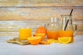 Orange juice in the glass jar and fresh orange fruit slice on wooden table - Still life glass juice on wood background Royalty Free Stock Photo