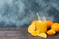 Orange juice in glass jar and fresh fruits oranges on dark background with copy space Royalty Free Stock Photo