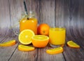 Orange juice in the glass jar and fresh orange fruit slice on wooden table - Still life glass juice on dark background Royalty Free Stock Photo