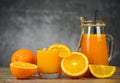 Orange juice in the glass jar and fresh orange fruit slice on wooden table - Still life glass juice on dark with copy space Royalty Free Stock Photo