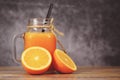 Orange juice in the glass jar and fresh orange fruit slice on wooden table / Still life glass juice on dark Royalty Free Stock Photo