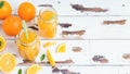 Orange juice in glass jars and fresh oranges on a white wooden rustic background Royalty Free Stock Photo