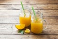 Orange juice in glass jars and fresh oranges on a wooden rustic background. Copy space Royalty Free Stock Photo