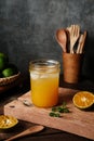 Orange juice in glass with mint, fresh fruits on wooden board. Royalty Free Stock Photo