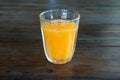 orange juice glass on wood table