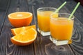Orange juice in the glasses on a wooden table Royalty Free Stock Photo