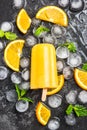 Orange juice homemade popsicle over ice Royalty Free Stock Photo