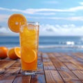 Orange juice with ice on wooden balcony by the sea Royalty Free Stock Photo