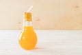 orange juice in lamp shape glass