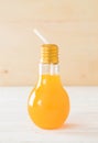 orange juice in lamp shape glass