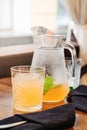 Orange juice lemonade in glass jar with mint leaf. Summer detox dit in restaurant. Outdoors Royalty Free Stock Photo