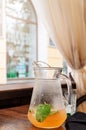 Orange juice lemonade in glass jar with mint leaf. Summer detox dit in restaurant. Outdoors Royalty Free Stock Photo