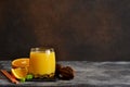 Orange juice, oranges and and juicer on stone background. Horizontal shot Royalty Free Stock Photo