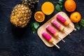 Orange juice, oranges, mandarins, pineapple and citrus ice cream on wooden table background top view copyspace Royalty Free Stock Photo