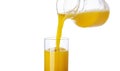 Orange juice pouring from pitcher into glass isolated on white background Royalty Free Stock Photo