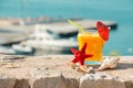 Orange juice, sea and seashells. Royalty Free Stock Photo