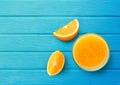 100% Orange juice with sliced on blue wood Royalty Free Stock Photo