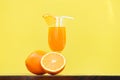 Orange juice summer glass with piece orange fruit with yellow Royalty Free Stock Photo