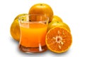 Orange juice in transparent glass with pile of orange fruit Royalty Free Stock Photo