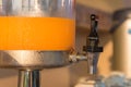 Orange juice in water cooler for breakfast at the hotel Royalty Free Stock Photo