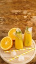 Orange juice on a wooden tray. Sliced orange and ice cubes Royalty Free Stock Photo