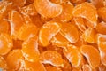 Orange juicy tangerine slices as a textured background. Flat lay. Fresh summer vitamin rich fruits. Macro shot Royalty Free Stock Photo