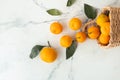 Orange juicy tangerine slices and peeled mandarines scattered on the white marble background. Flat lay. Copy space. Fresh summer Royalty Free Stock Photo