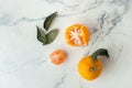 Orange juicy tangerine slices and peeled mandarines scattered on the white marble background. Flat lay. Copy space. Fresh summer Royalty Free Stock Photo