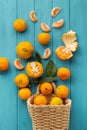 Orange juicy tangerine slices and peeled mandarines scattered on the wooden turquoise background. Flat lay. Copy space. Fresh Royalty Free Stock Photo