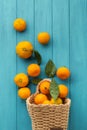 Orange juicy tangerine slices and peeled mandarines scattered on the wooden turquoise background. Flat lay. Copy space. Fresh Royalty Free Stock Photo