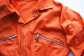 An orange jumpsuit of a prisoner. Prison clothes, jumpsuit sentenced to correctional labor,community payback Royalty Free Stock Photo