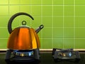 Orange kettle on the gas-stove