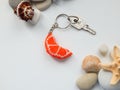 Orange key chain and sea coast